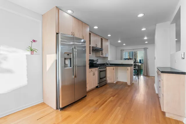 a kitchen with stainless steel appliances a refrigerator sink and cabinets