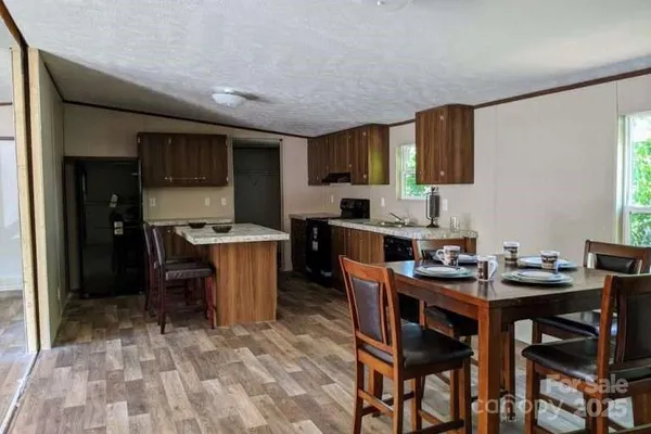 a bathroom with a granite countertop sink toilet and a mirror