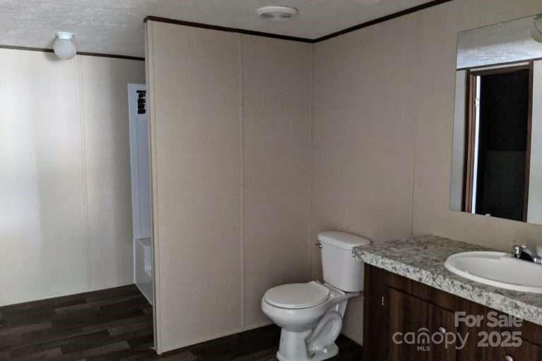 2294 Old Georgetown Road West, Unit 2 Cassatt, SC 29032 - Photo 12 of 12 a bathroom with a granite countertop sink toilet and a mirror