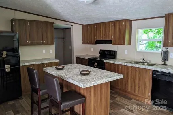 a kitchen with a table chairs and a refrigerator