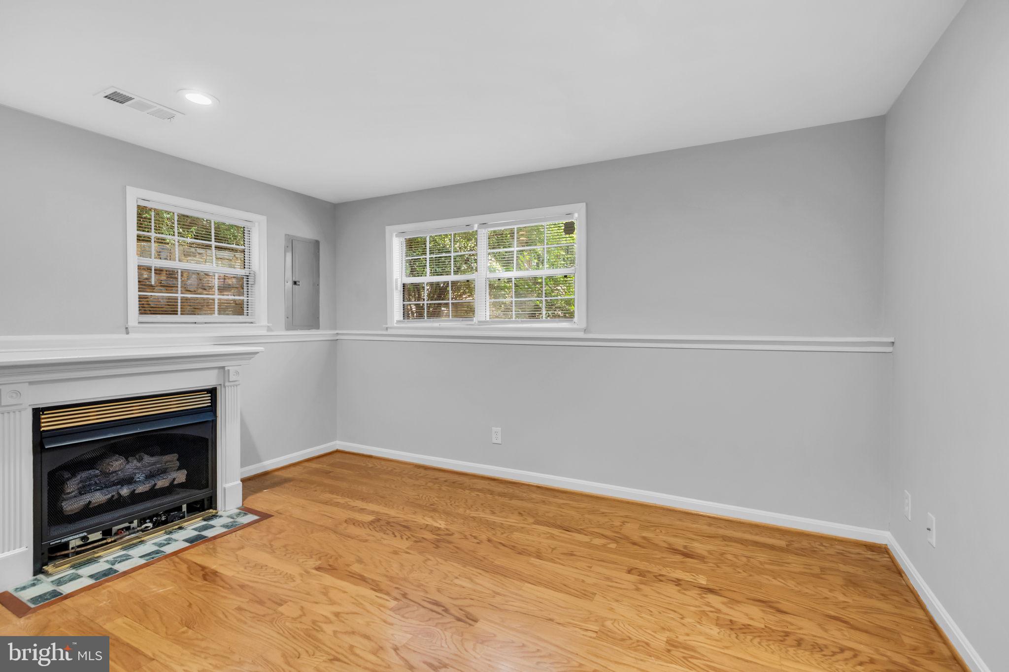 6013 Riddle Walk Alexandria, VA 22312 - Photo 28 of 31 an empty room with windows and fireplace