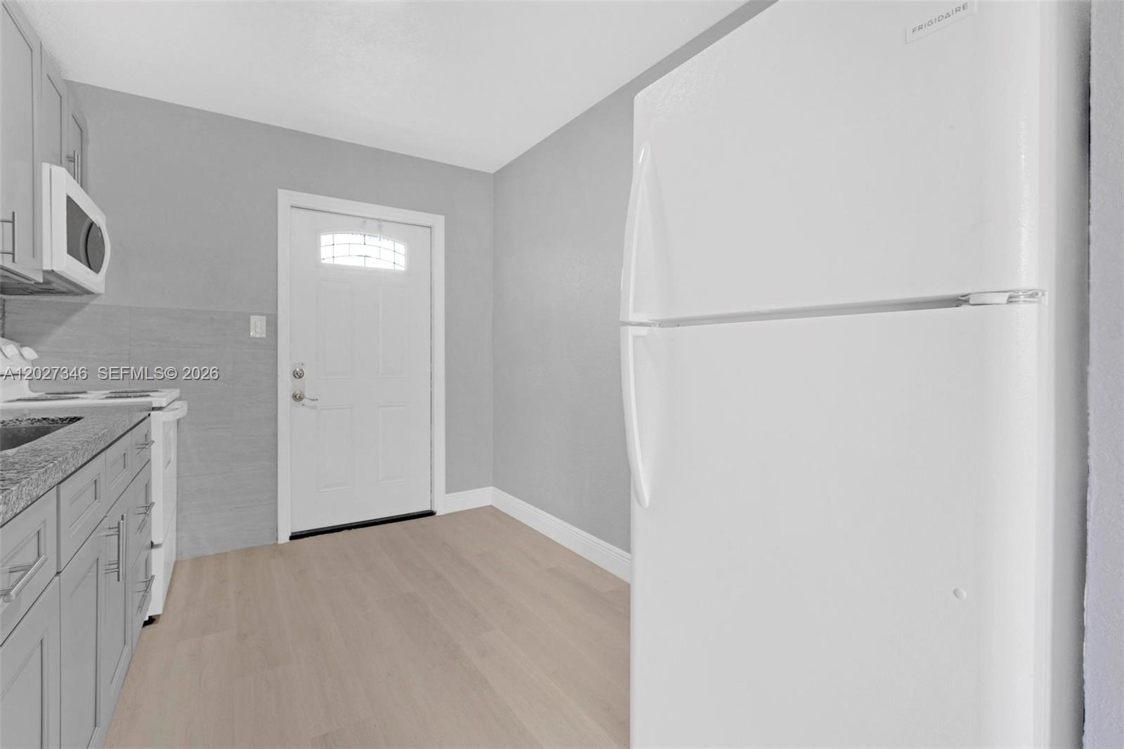 369 Phippen Waiters Road, Unit FRONT Dania Beach, FL 33004 - Photo 8 of 19 a view of a kitchen with a sink