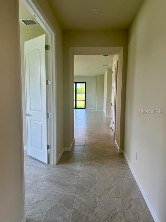 4139 Silver Maple Way Vero Beach, FL 32967 - Photo 14 of 29 a view of a hallway with wooden shelves