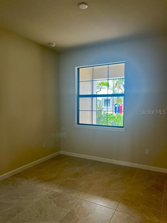 4139 Silver Maple Way Vero Beach, FL 32967 - Photo 17 of 29 an empty room with a window