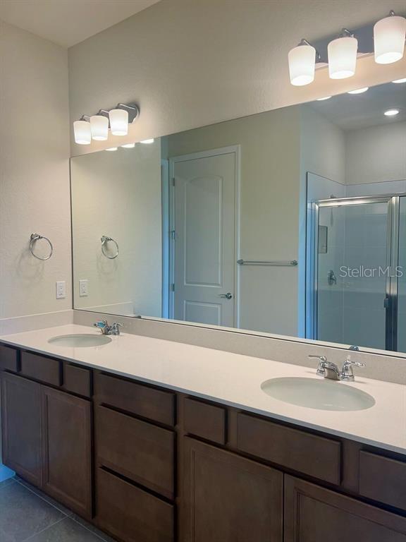 4139 Silver Maple Way Vero Beach, FL 32967 - Photo 6 of 29 a bathroom with a sink and a mirror