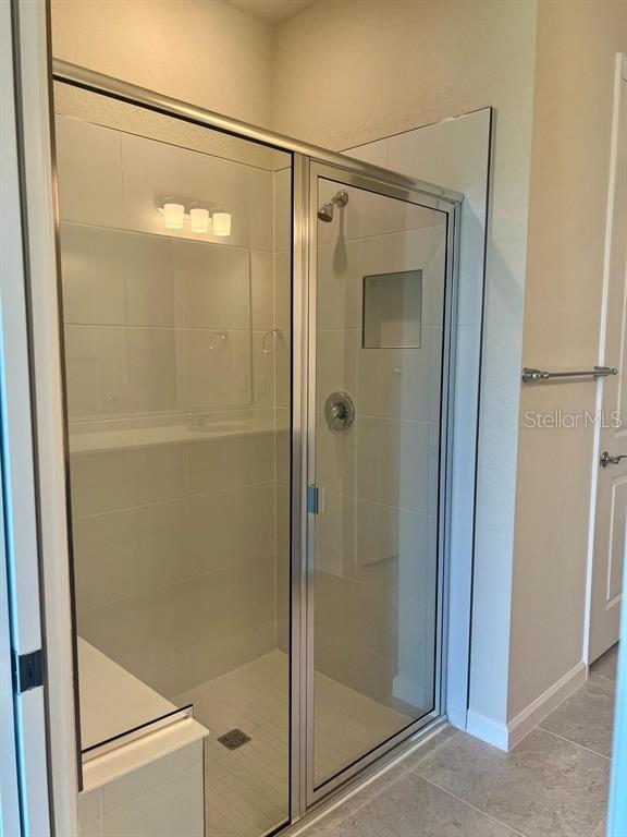 4139 Silver Maple Way Vero Beach, FL 32967 - Photo 8 of 29 a bathroom with a glass shower door