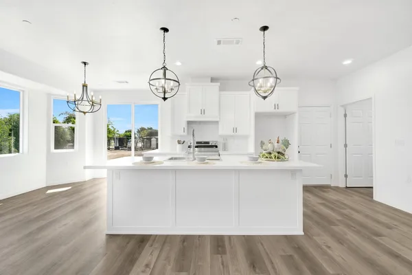 a view of a kitchen with wooden floor and window