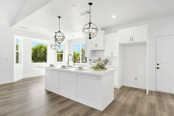 a kitchen with wooden floor and window