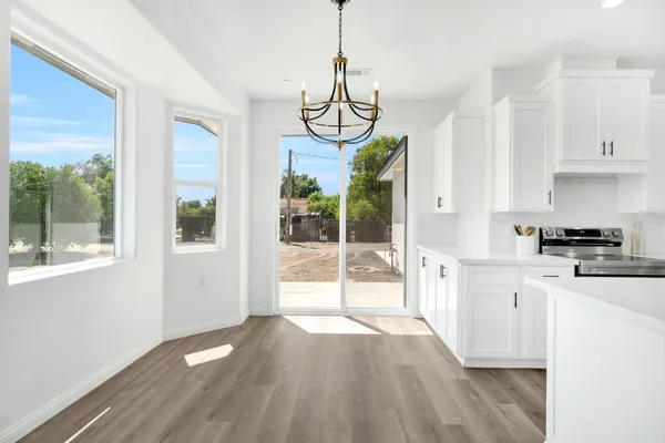 a view of a kitchen with wooden floor and a window