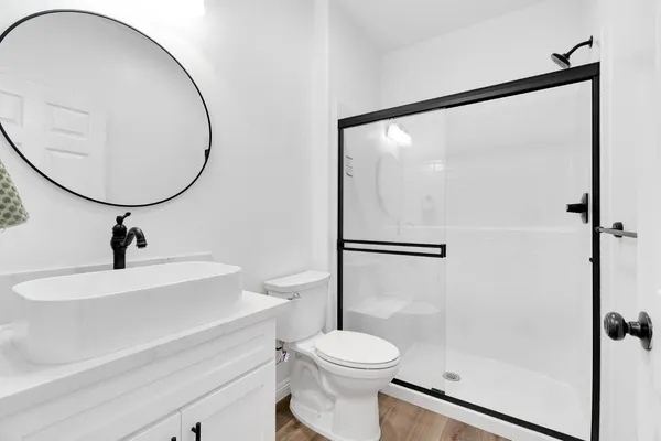 a bathroom with a toilet a sink and a mirror