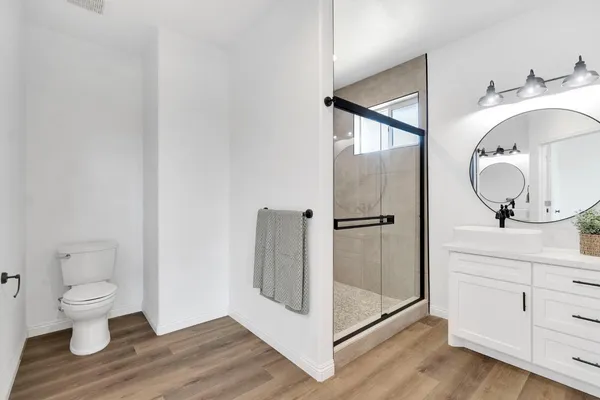 a bathroom with a toilet a sink and mirror