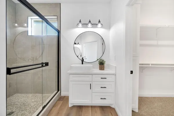 a bathroom with a mirror and vanity