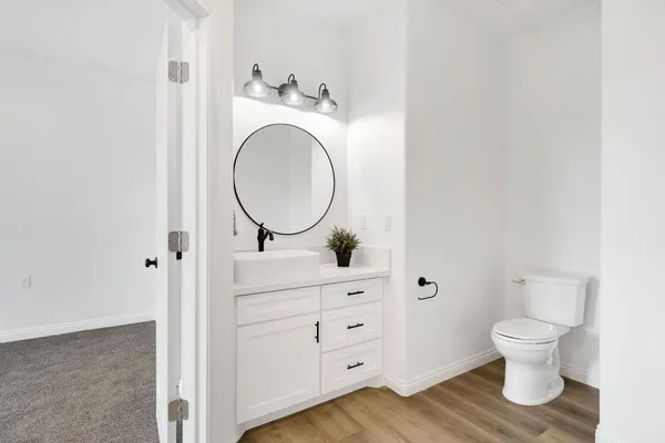 a bathroom with a toilet sink and mirror