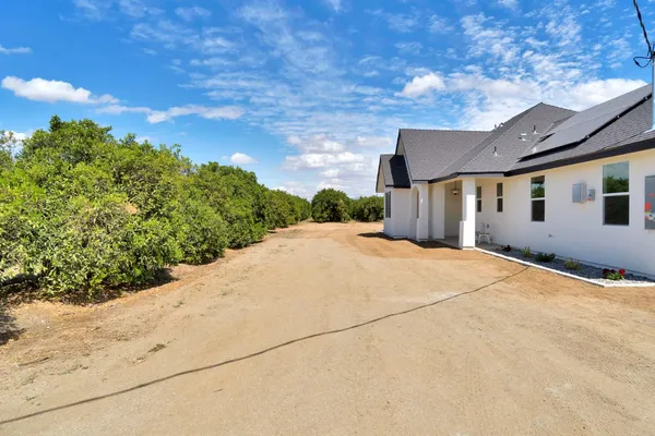 a very nice looking house with a large parking space
