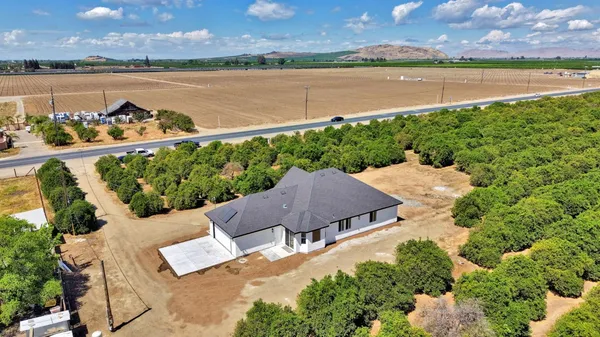 an aerial view of ocean with residential house with outdoor space and seating