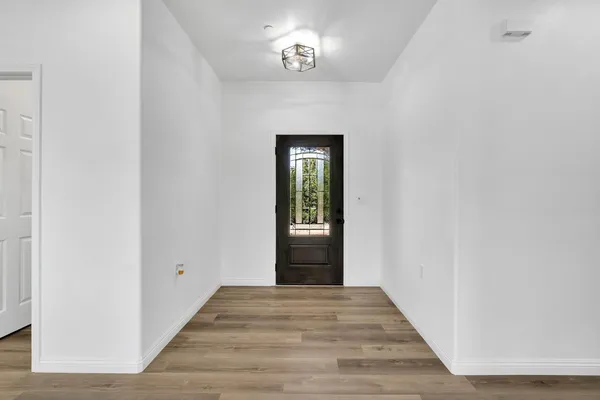 a view of a hallway with wooden floor