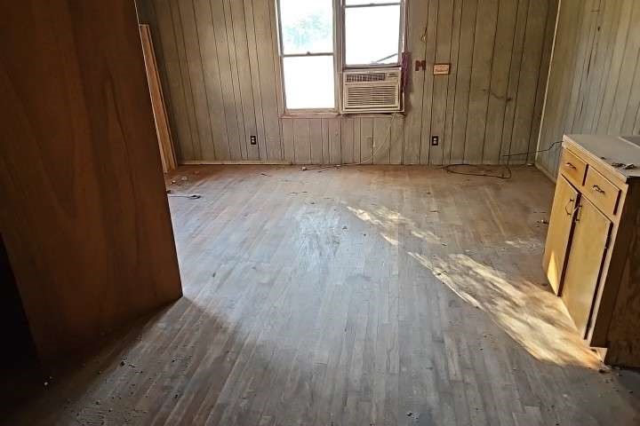644 16th Street Colorado City, TX 79512 - Photo 3 of 12 an empty room with wooden floor and windows