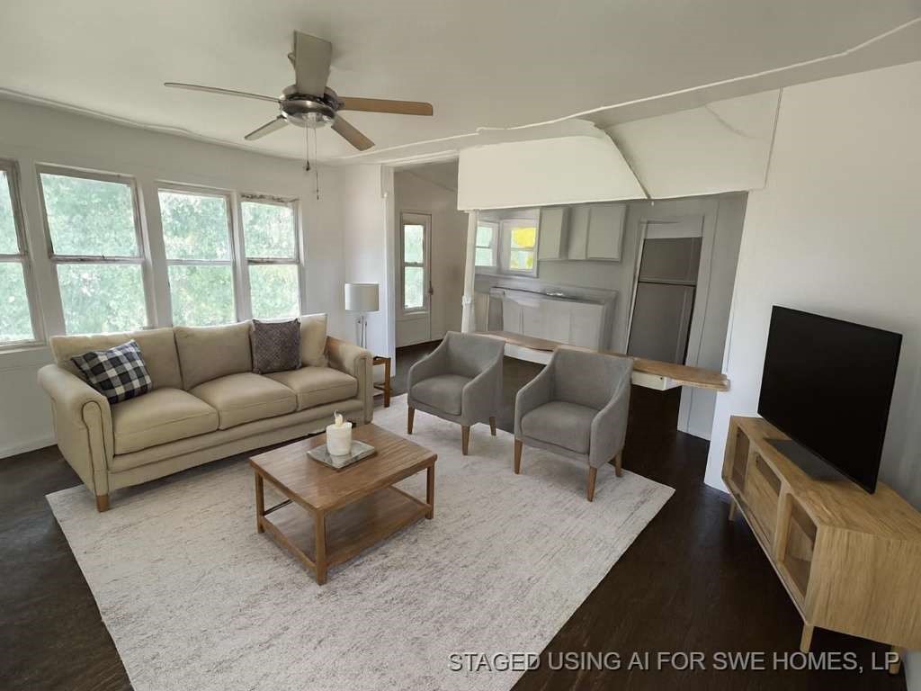 644 16th Street Colorado City, TX 79512 - Photo 4 of 12 a living room with furniture a large window and a flat screen tv