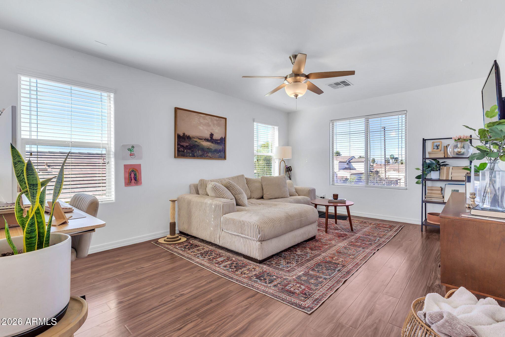 4120 South Butte Lane Gilbert, AZ 85297 - Photo 13 of 29 a living room with furniture and wooden floor