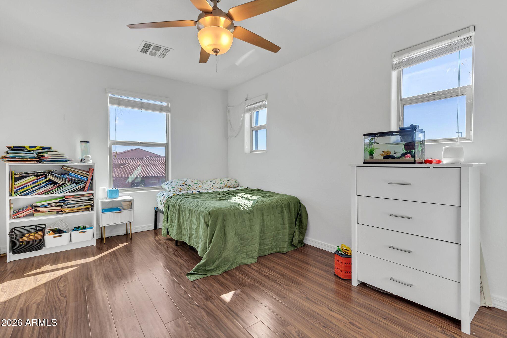 4120 South Butte Lane Gilbert, AZ 85297 - Photo 22 of 29 a bedroom with a bed and a chandelier