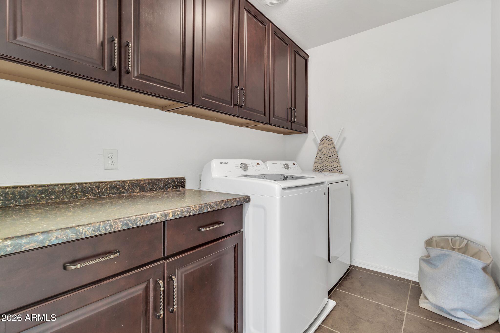 4120 South Butte Lane Gilbert, AZ 85297 - Photo 26 of 29 a utility room with granite countertop cabinets washer and dryer