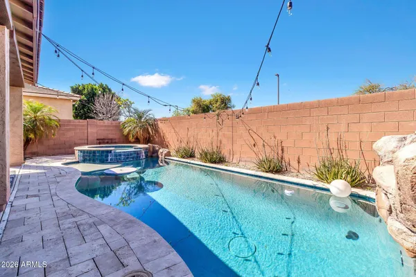 a view of a swimming pool with a patio