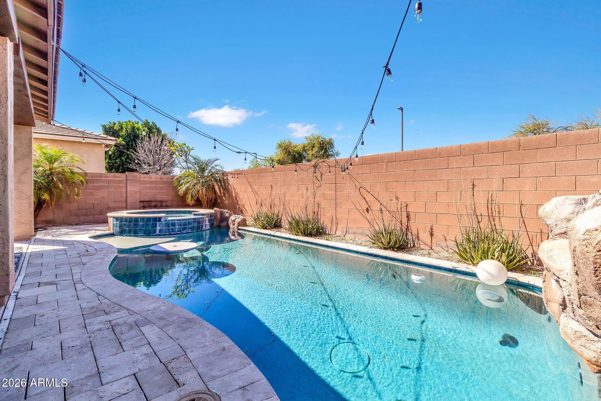 4120 South Butte Lane Gilbert, AZ 85297 - Photo 4 of 29 a view of a swimming pool with a patio