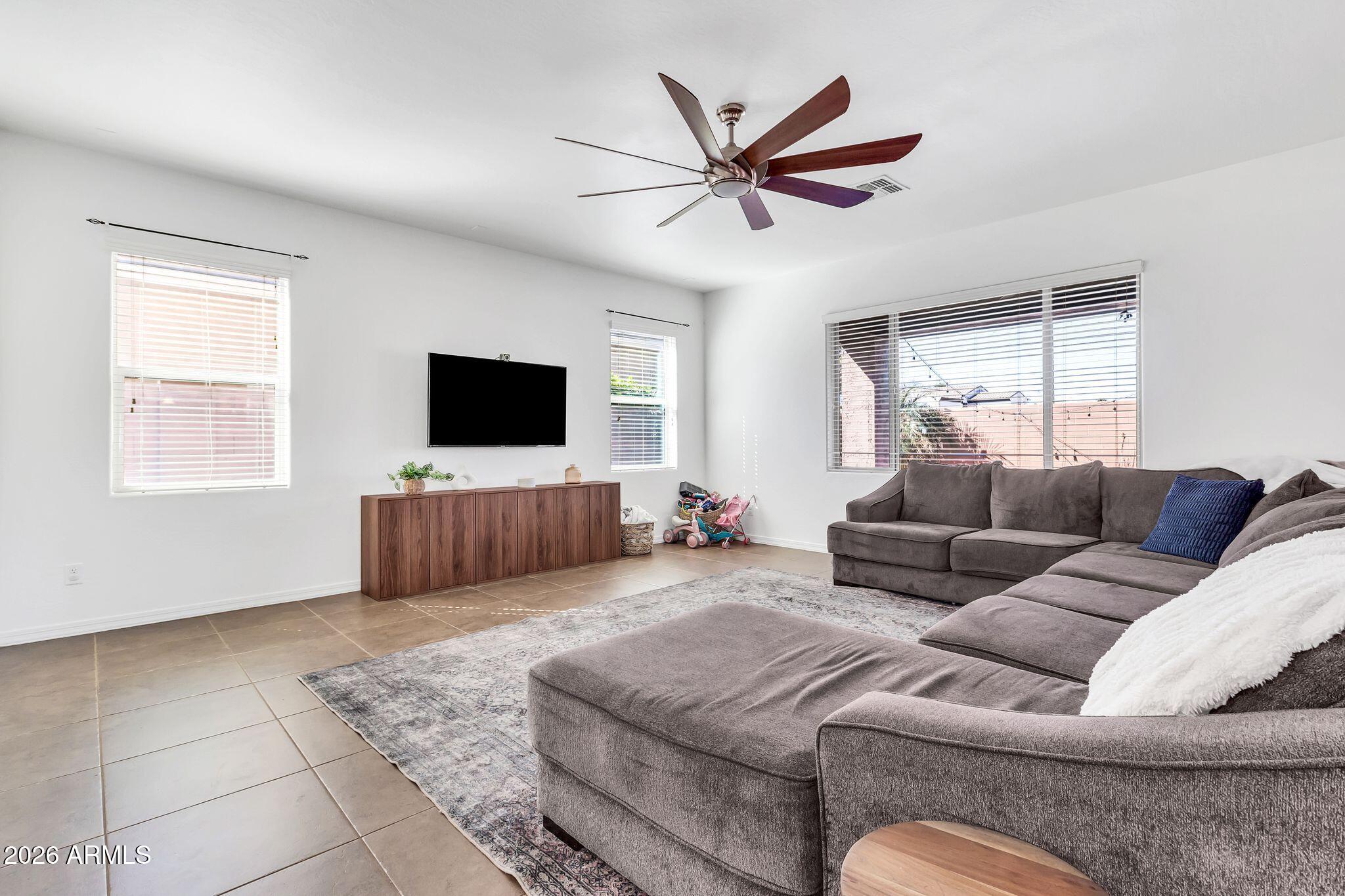 4120 South Butte Lane Gilbert, AZ 85297 - Photo 7 of 29 a living room with furniture and a flat screen tv