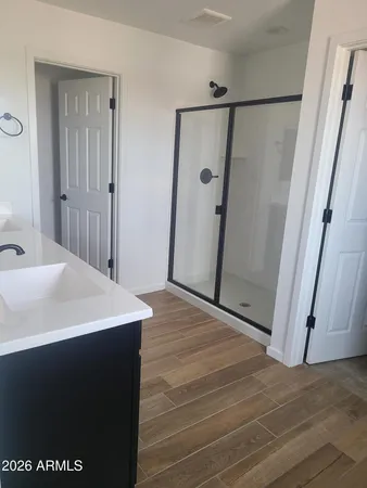 a view of a room with wooden floor and a sink