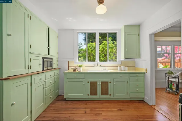 a spacious bathroom with a double vanity sink large mirror and window
