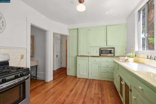 a kitchen with wooden floors and appliances