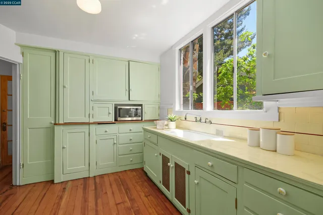 a kitchen with a sink and large window