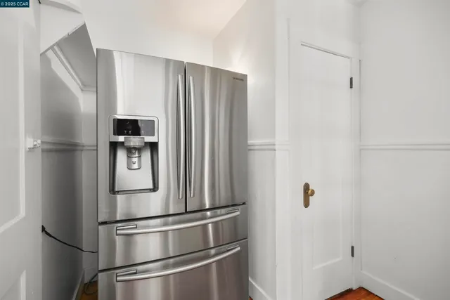 a metallic refrigerator freezer sitting in a kitchen