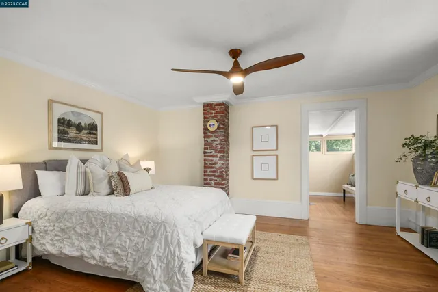 a bedroom with a large bed and a chandelier