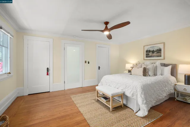 a spacious bedroom with a bed and a chandelier