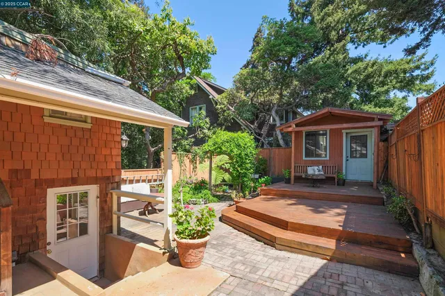 a front view of a house with plants