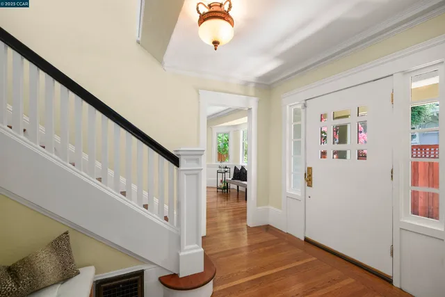 a view of entryway with wooden floor and stairs