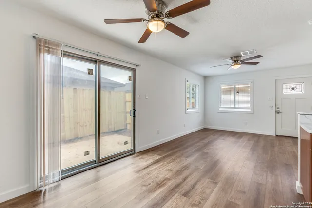 wooden floor in an empty room with a window
