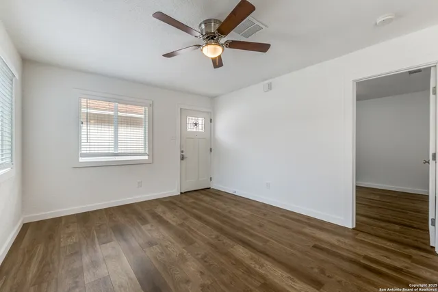 wooden floor in an empty room with a window