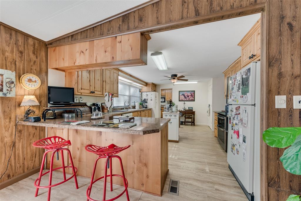 510 North D Ranch Road Waxahachie, TX 75167 - Photo 13 of 38 a kitchen with stainless steel appliances granite countertop a refrigerator and stove top oven