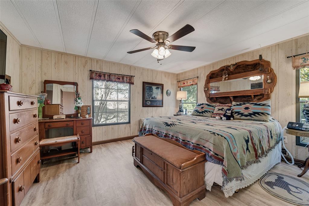 510 North D Ranch Road Waxahachie, TX 75167 - Photo 15 of 38 a spacious bedroom with a bed a couch and a chandelier