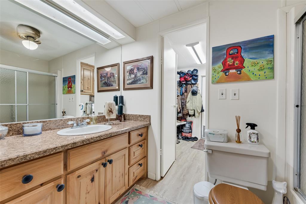 510 North D Ranch Road Waxahachie, TX 75167 - Photo 19 of 38 a en suite bathroom with double vanity sinks a mirror and a shower