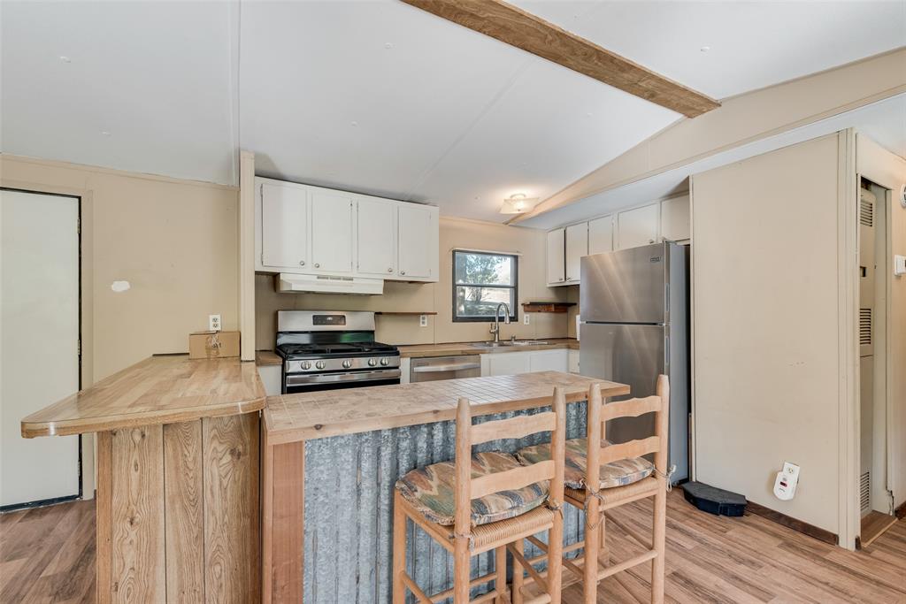 510 North D Ranch Road Waxahachie, TX 75167 - Photo 25 of 38 a kitchen with stainless steel appliances a stove a refrigerator and a refrigerator