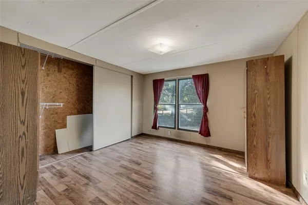 a view of balcony with wooden floor and iron fence