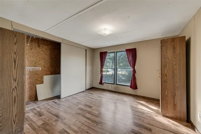 a view of balcony with wooden floor and iron fence