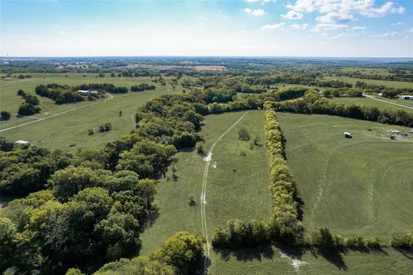 an aerial view of a houses with a yard