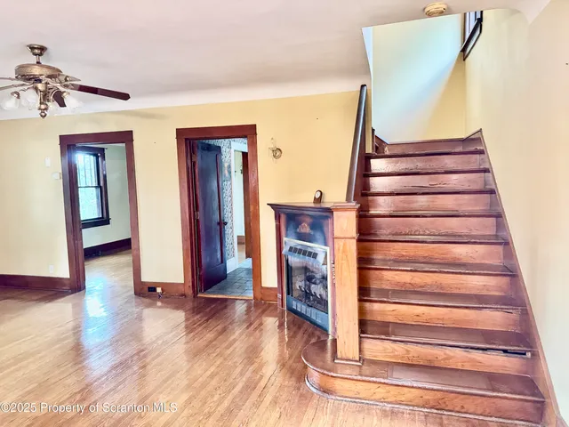a view of empty room with wooden floor