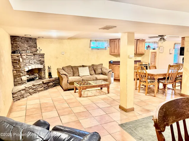 a living room with stainless steel appliances kitchen island granite countertop furniture and a kitchen view
