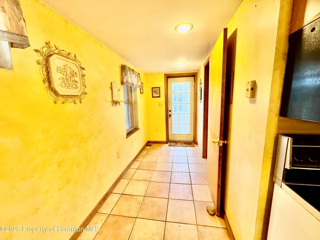 a room with water heater and wooden floor