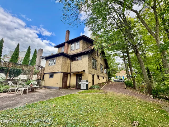 a view of an entryway wooden floor and a rug